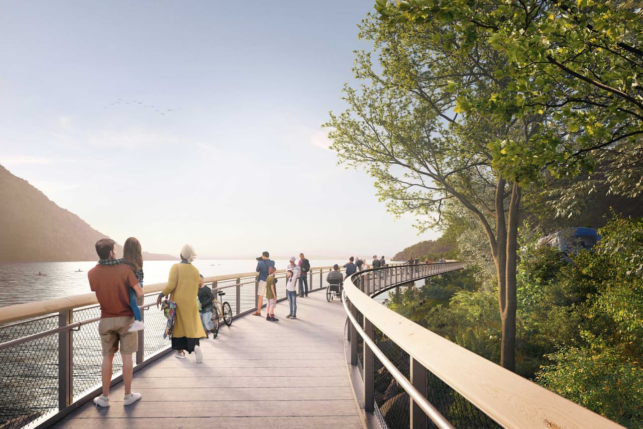 Artist's rendering of a wide deck on the proposed trail at dusk, people leaning on the river rail and cyclists passing behind them, with the water and the far shore in soft evening light.